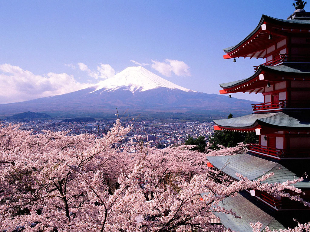 Scenic view of Mount Fuji with a traditional red pagoda and cherry blossoms in the foreground, representing the Japanese landscape.