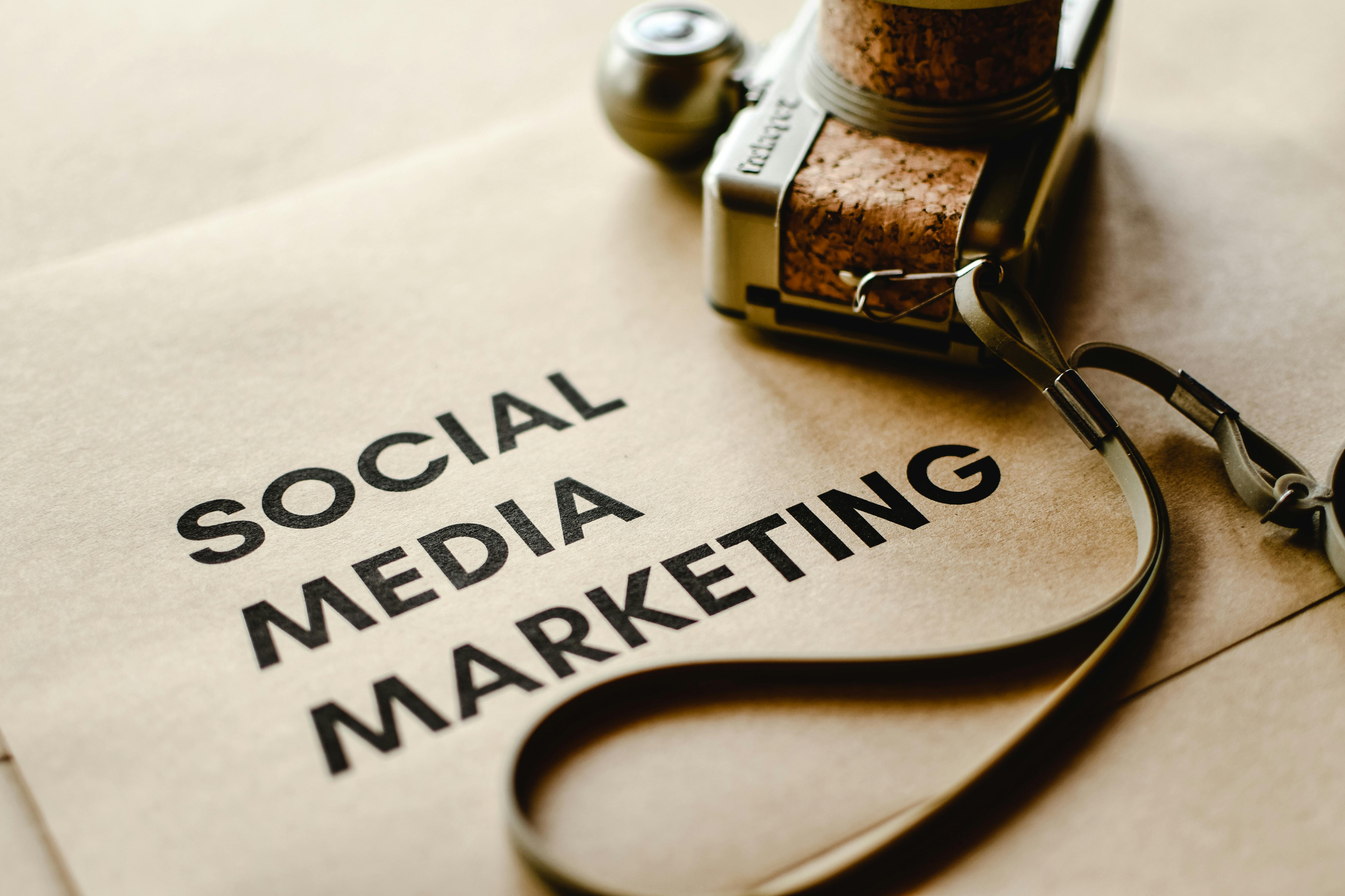 Flat lay of a camera on a table with the words "Social Media Marketing" printed underneath, symbolizing digital branding strategies