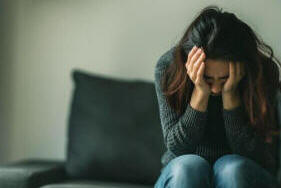 A woman that seems upset and tired