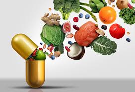 Golden capsule with fresh fruits, vegetables, and fish spilling out, representing natural sources of vitamins