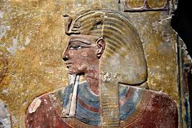 Ancient Egyptian Pharaoh seated on throne wearing the double crown of Upper and Lower Egypt