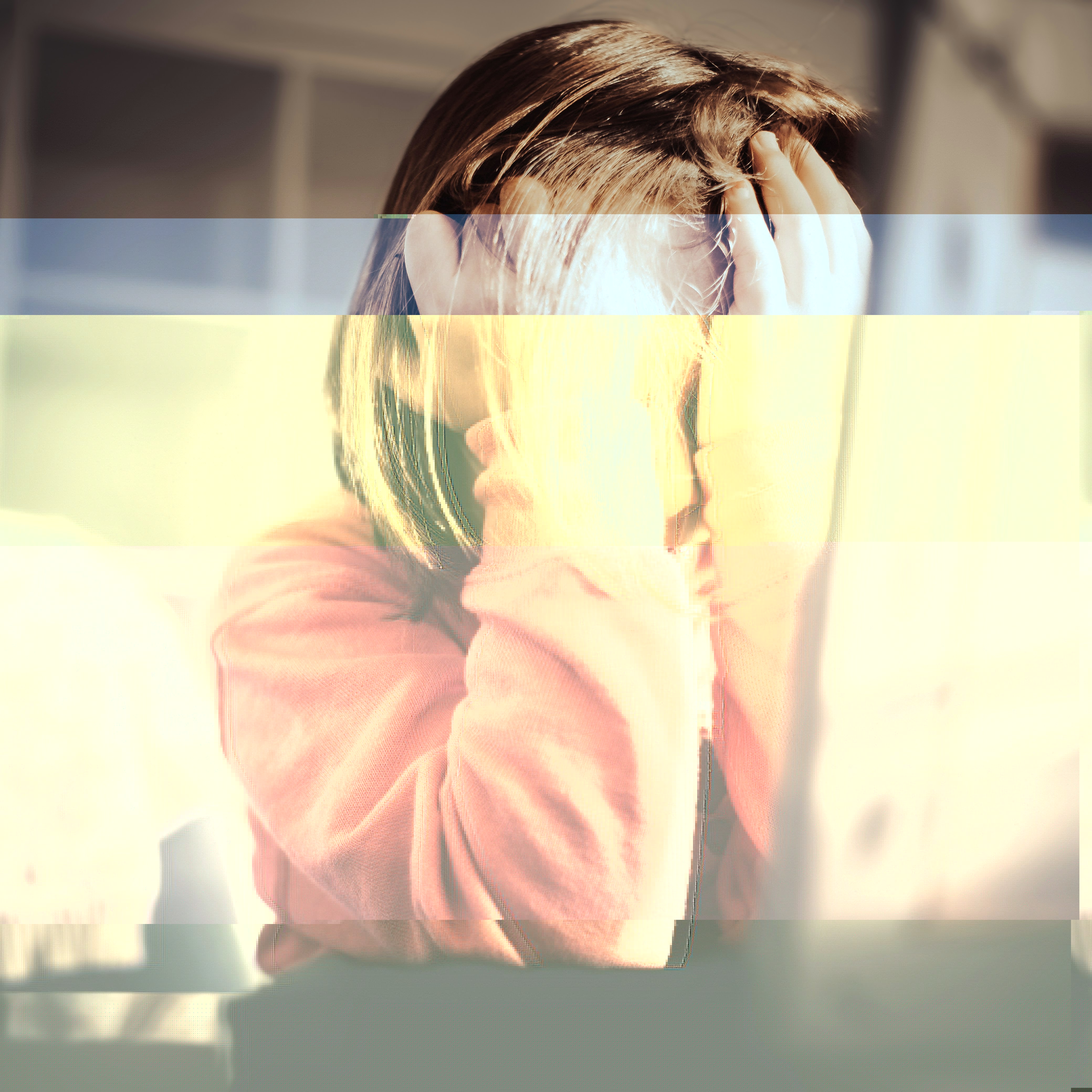Child sitting at desk looking distracted, representing ADHD inattentive symptoms